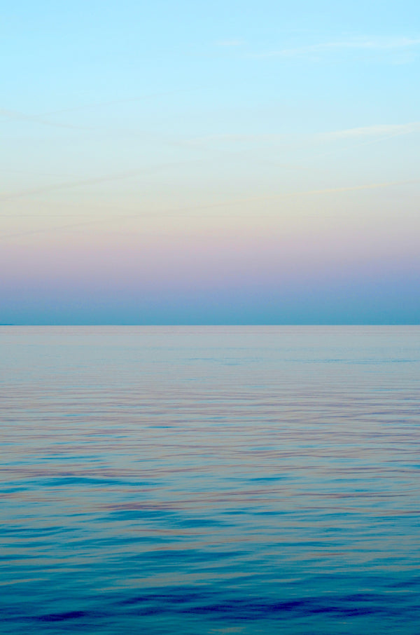 Soft pastel sky calm ocean for Zodiaque Moon monthly horoscopes