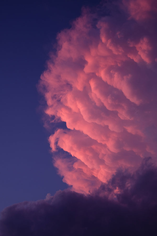Dramatic pink cloud against night sky for Zodiaque Moon monthly horoscopes