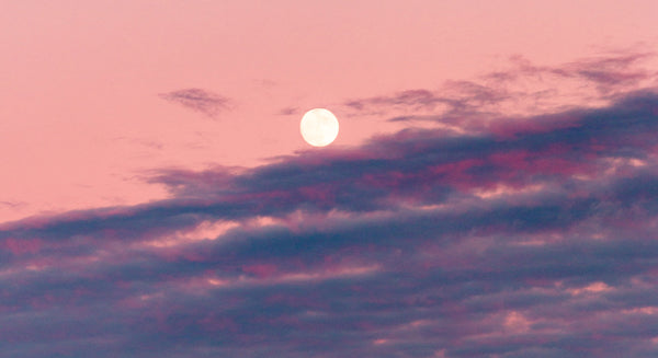 Peach and purple clouds with moon for Zodiaque Moon monthly horoscopes